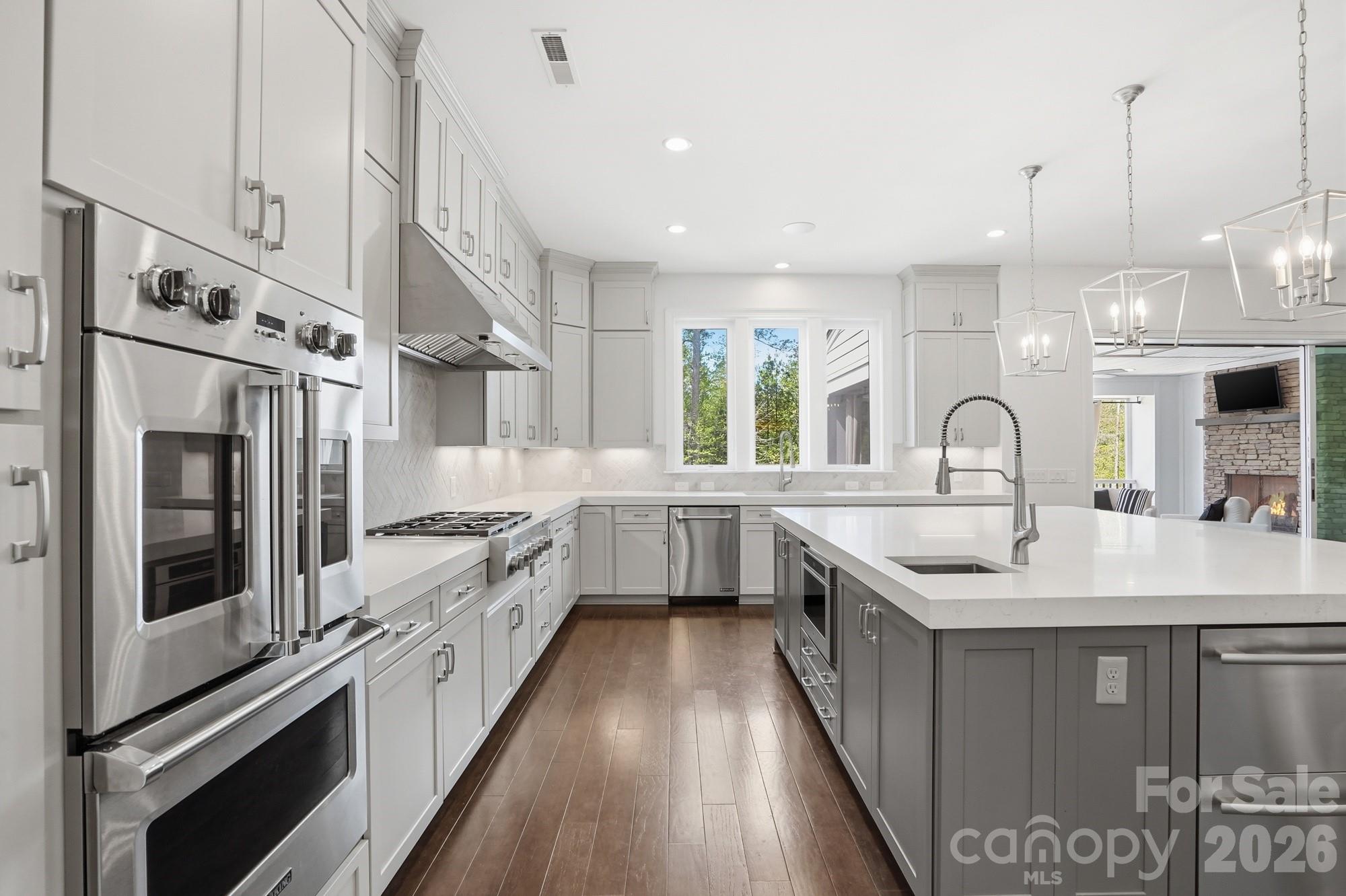 411 Turtleback Ridge Weddington, NC 28104 - Photo 17 of 48 a kitchen with stainless steel appliances a sink stove and refrigerator