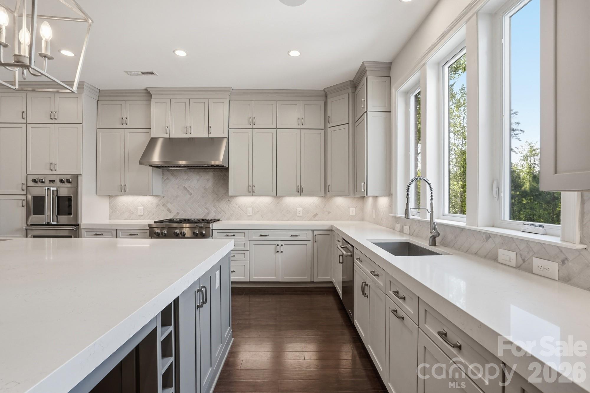 411 Turtleback Ridge Weddington, NC 28104 - Photo 18 of 48 a kitchen with a sink stove and cabinets