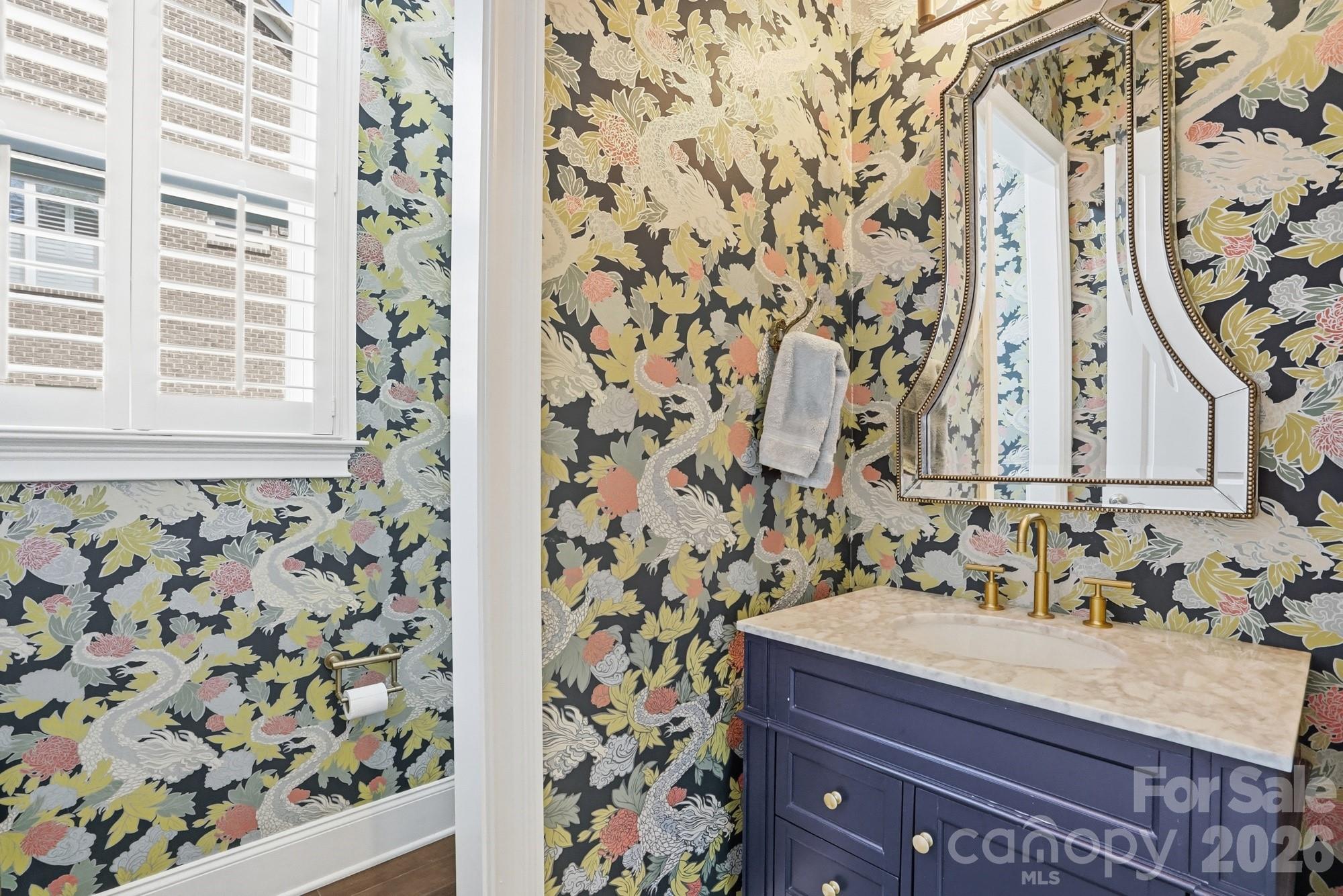 411 Turtleback Ridge Weddington, NC 28104 - Photo 23 of 48 wooden bathroom with a granite countertop sink and a mirror