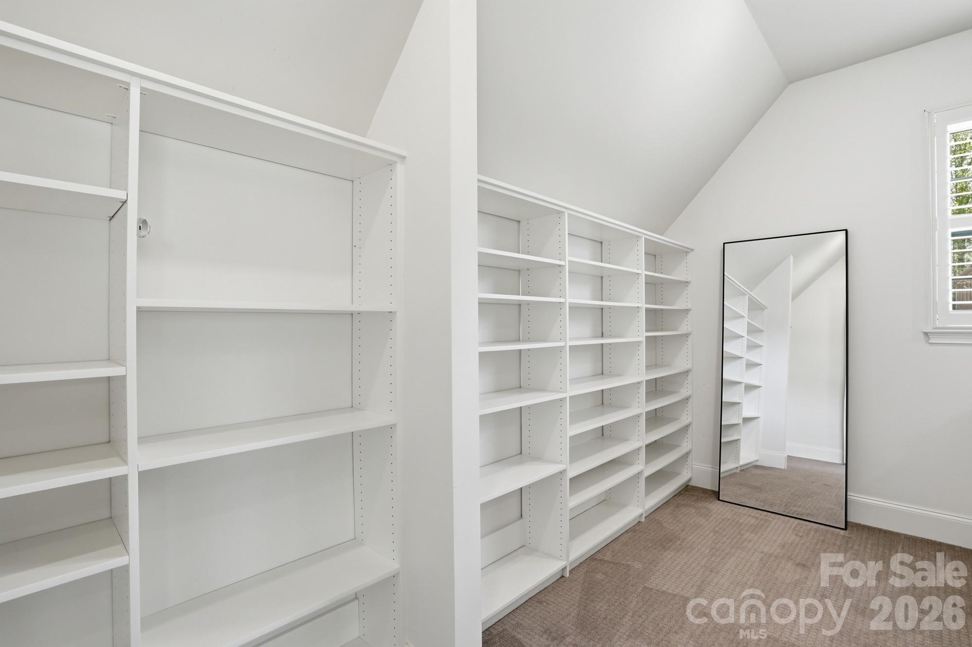411 Turtleback Ridge Weddington, NC 28104 - Photo 28 of 48 a view of room with walk in closet with empty racks