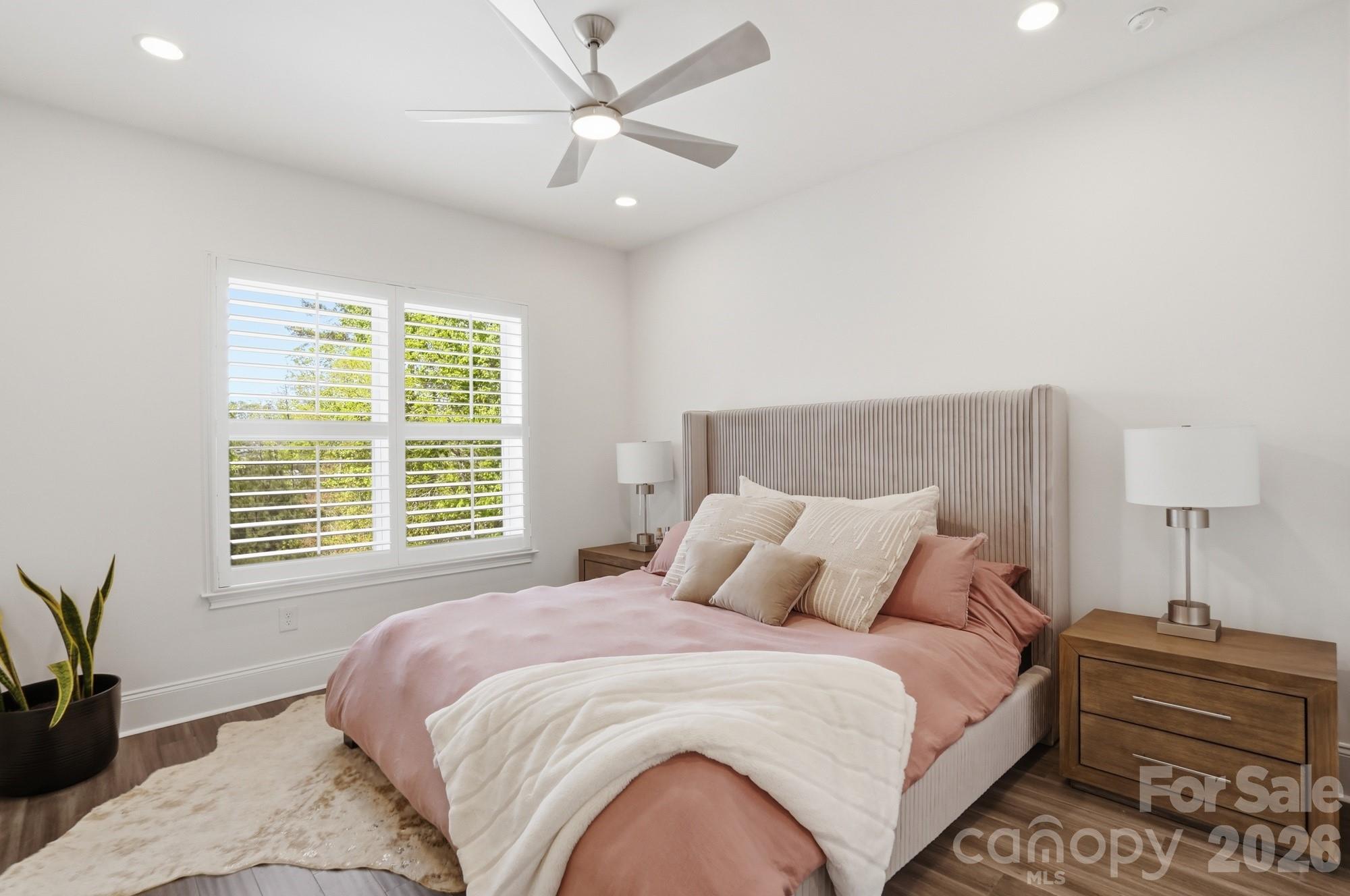 411 Turtleback Ridge Weddington, NC 28104 - Photo 32 of 48 a bedroom with a large bed and a chandelier