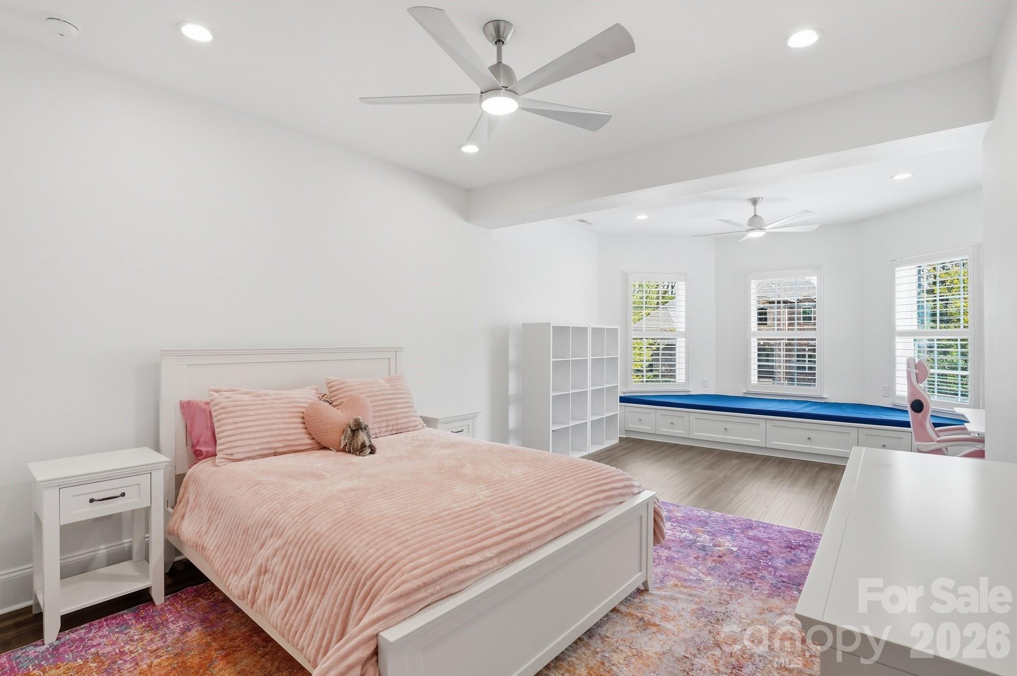 411 Turtleback Ridge Weddington, NC 28104 - Photo 33 of 48 a bedroom with a large bed and a chandelier