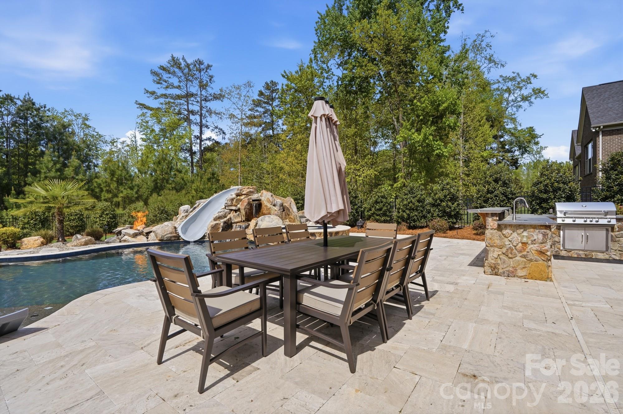 411 Turtleback Ridge Weddington, NC 28104 - Photo 39 of 48 a view of a patio with a table and chairs