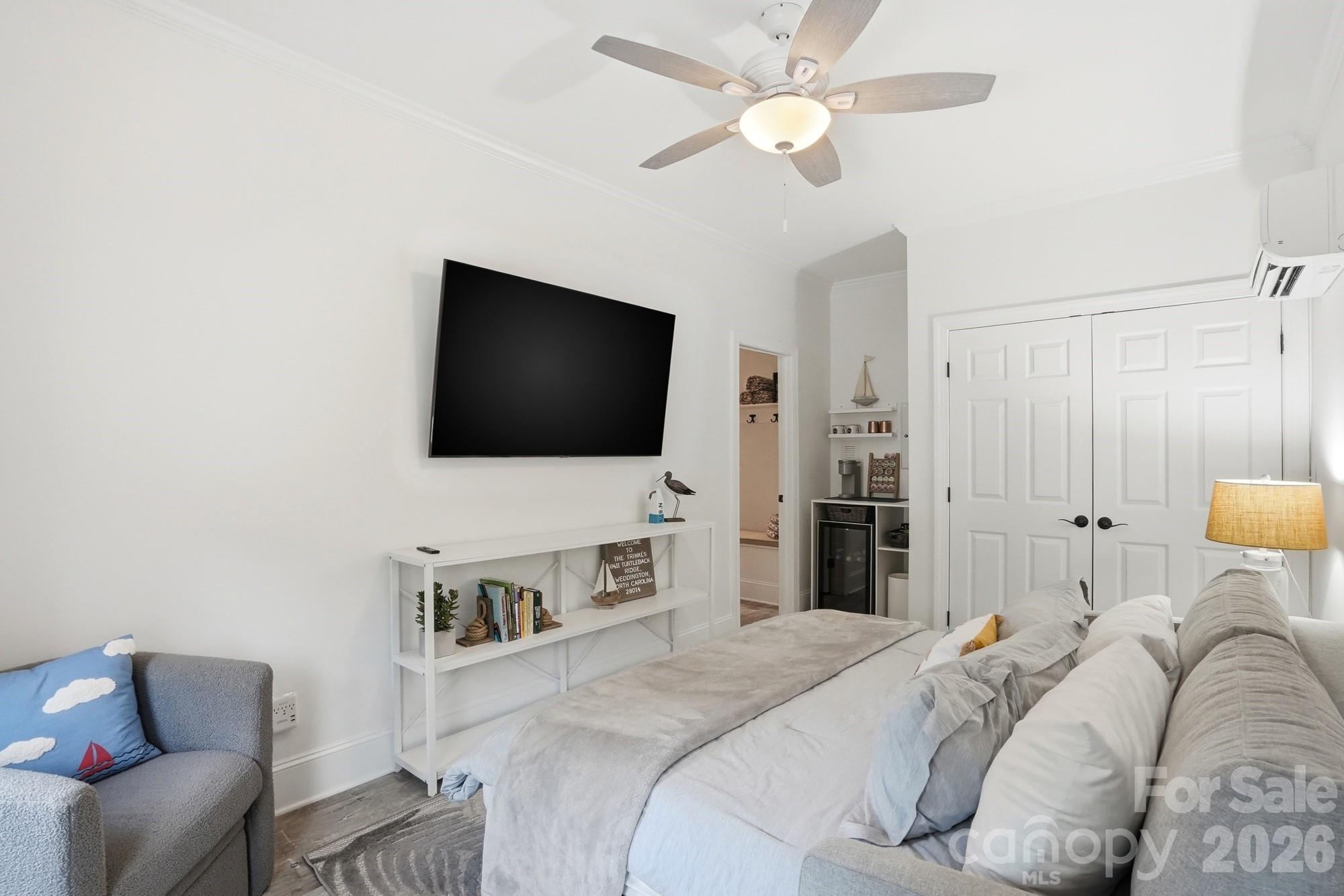 411 Turtleback Ridge Weddington, NC 28104 - Photo 44 of 48 a bedroom with a bed and a flat screen tv