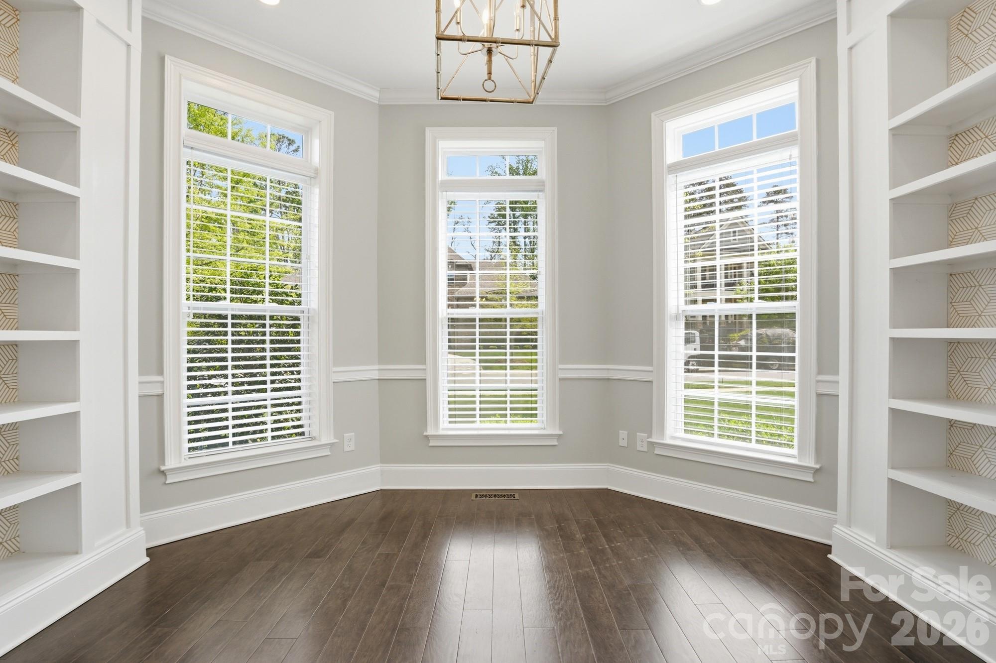 411 Turtleback Ridge Weddington, NC 28104 - Photo 9 of 48 a view of an empty room with wooden floor and windows