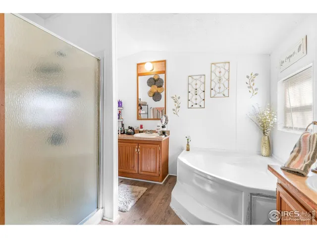 a bathroom with a sink a bathtub and a window