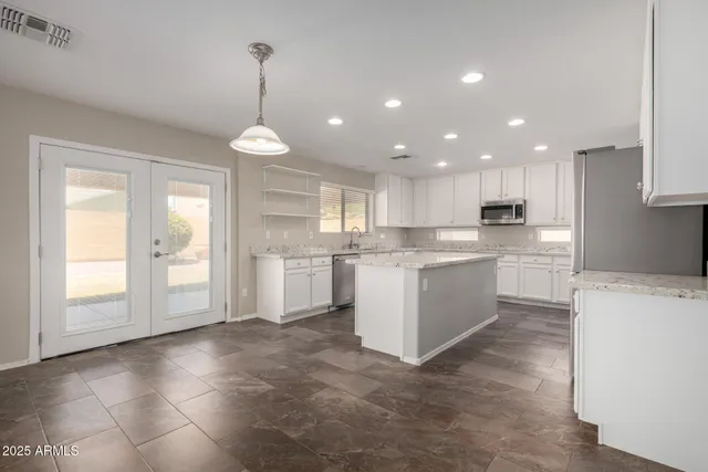 a kitchen with white cabinets and white appliances