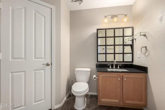 a bathroom with a toilet a sink and a window