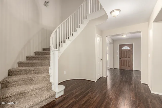 a view of entryway and hall with wooden floor