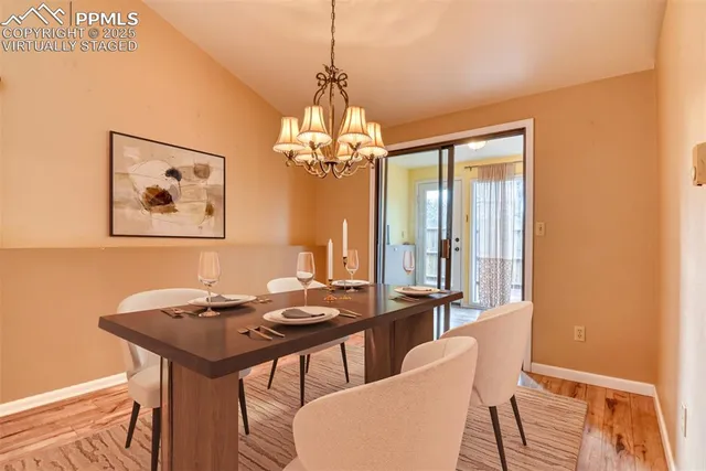 a living room with couches and kitchen view