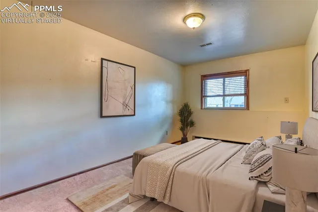 a bedroom with bed and wooden floor