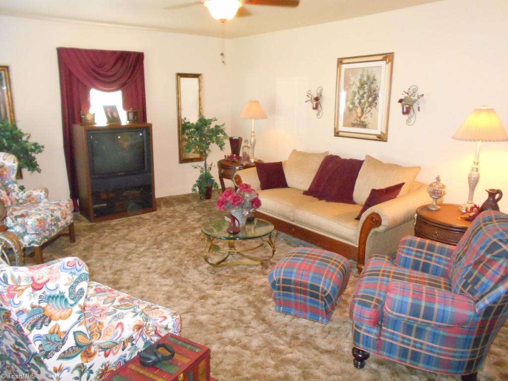 3505 Pine Valley Road High Point, NC 27265 - Photo 3 of 21 Large living room with ceiling fan and hardwoods hidden underneath the carpet