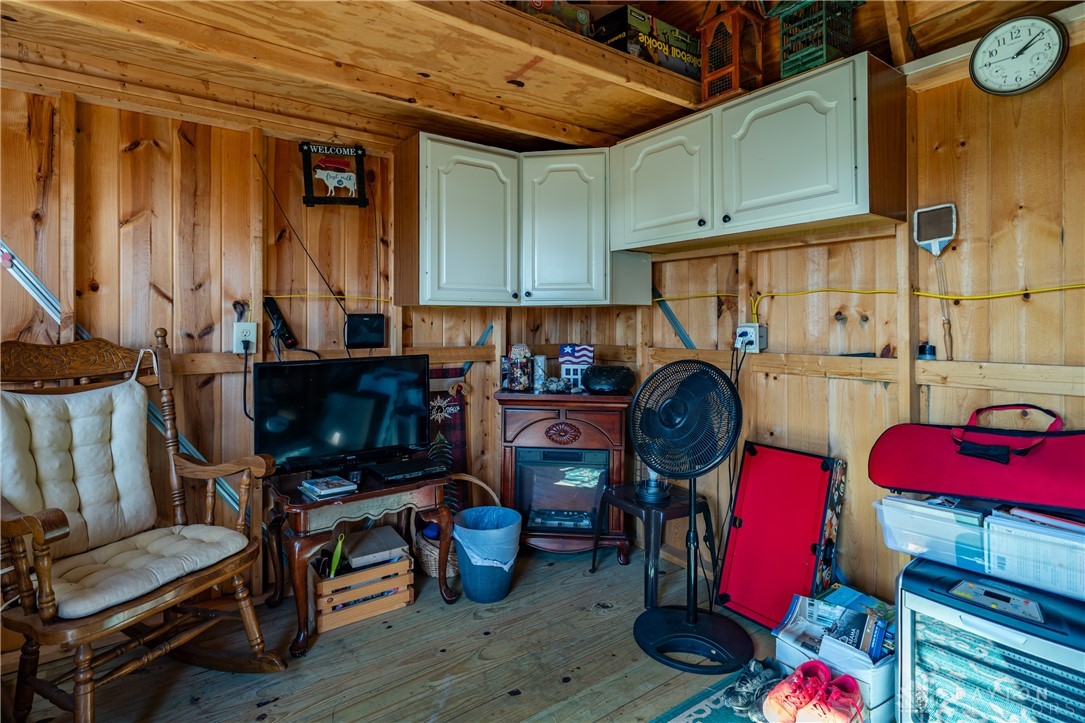 1599 Garringer Road Jamestown, OH 45335 - Photo 48 of 73 This cozy interior space features warm wood paneling and practical overhead cabinetry.