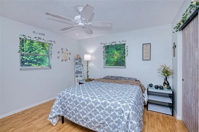 a bedroom with a bed and a potted plant