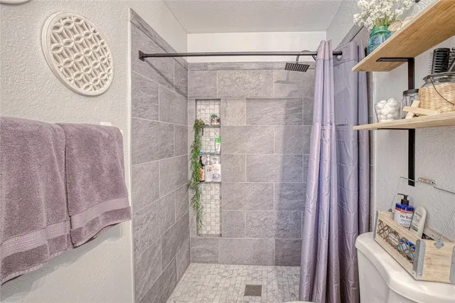 a bathroom with a bathtub and shower