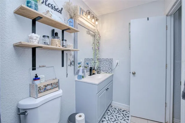 a bathroom with a sink a toilet and shower curtain