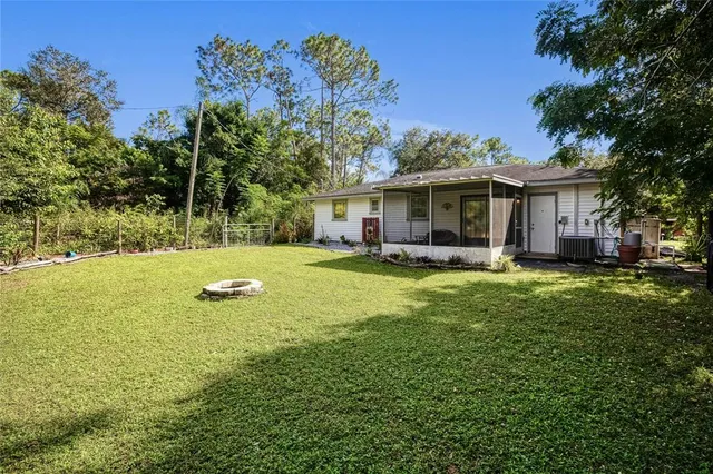 a view of a house with a backyard