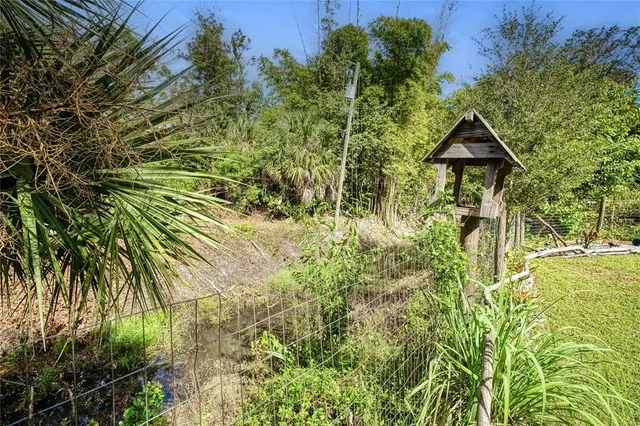 a view of a house with swimming pool and sitting area