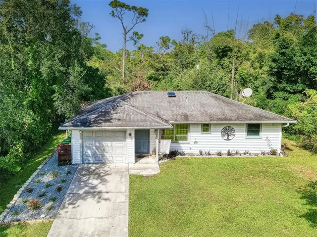 an aerial view of a house with yard
