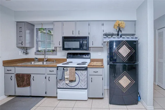 a kitchen with a sink appliances and cabinets