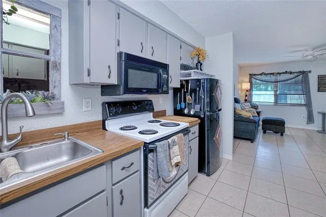 a kitchen that has a sink and a stove in it