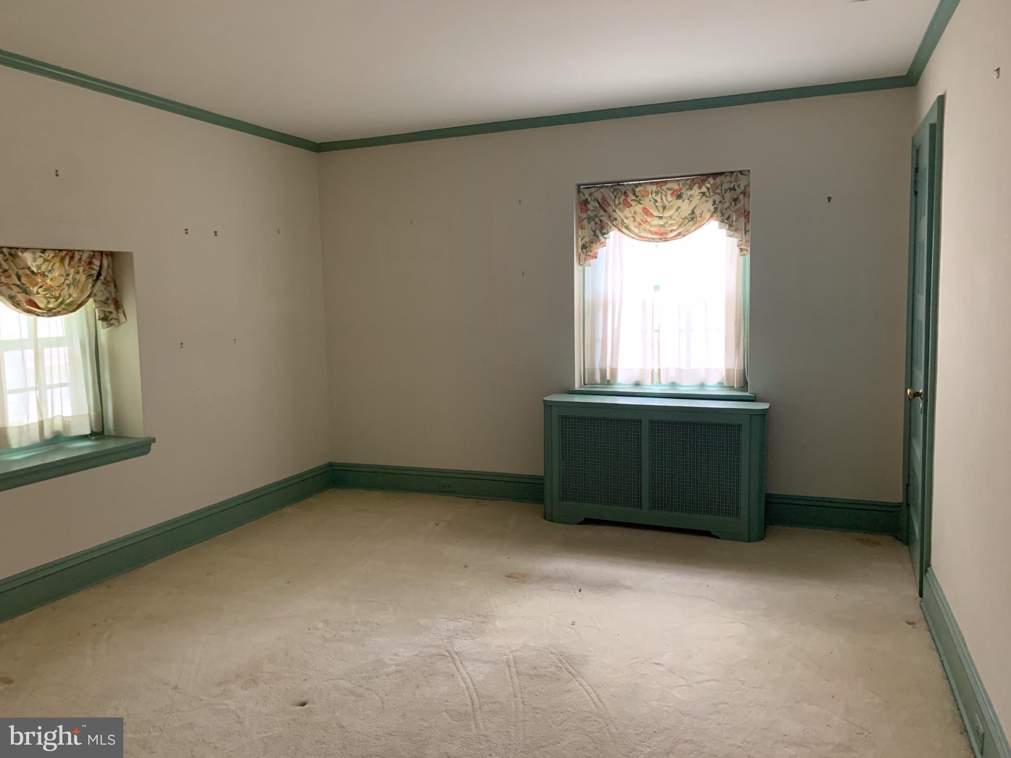 315 Kent Road Wynnewood, PA 19096 - Photo 16 of 19 an empty room with a window and a dresser