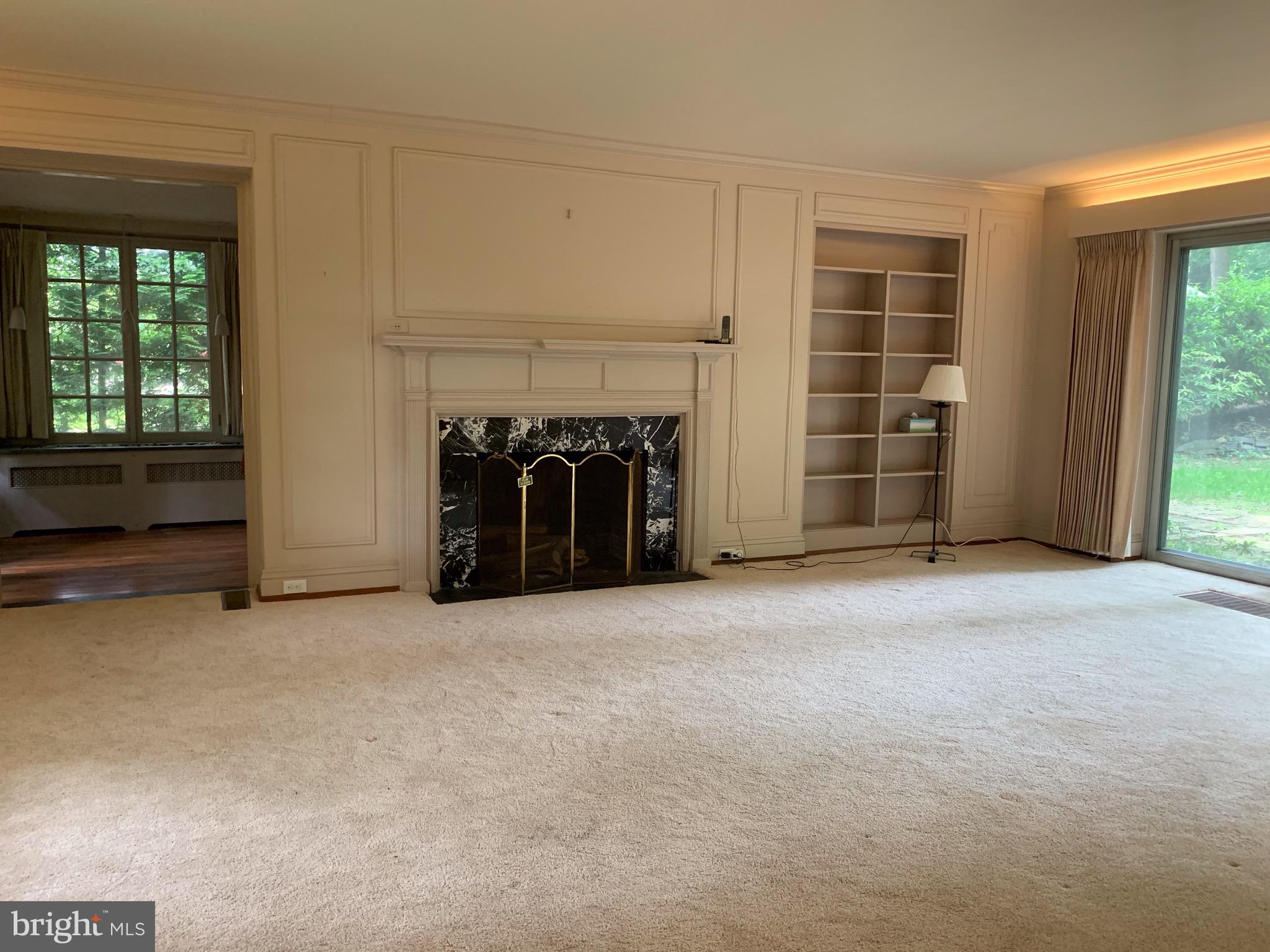 315 Kent Road Wynnewood, PA 19096 - Photo 5 of 19 an empty room with windows and fireplace