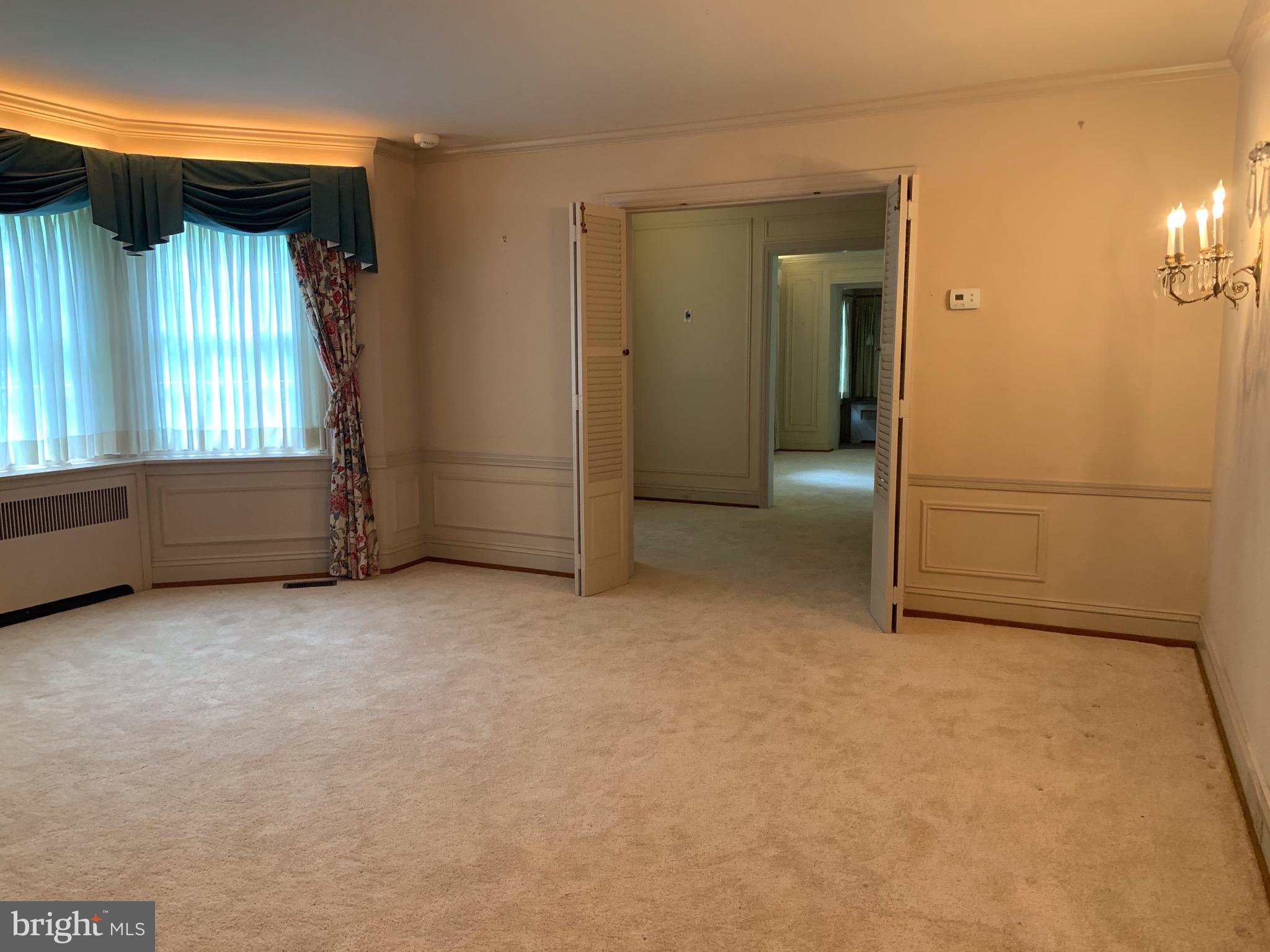 315 Kent Road Wynnewood, PA 19096 - Photo 8 of 19 an empty room with windows and cabinet
