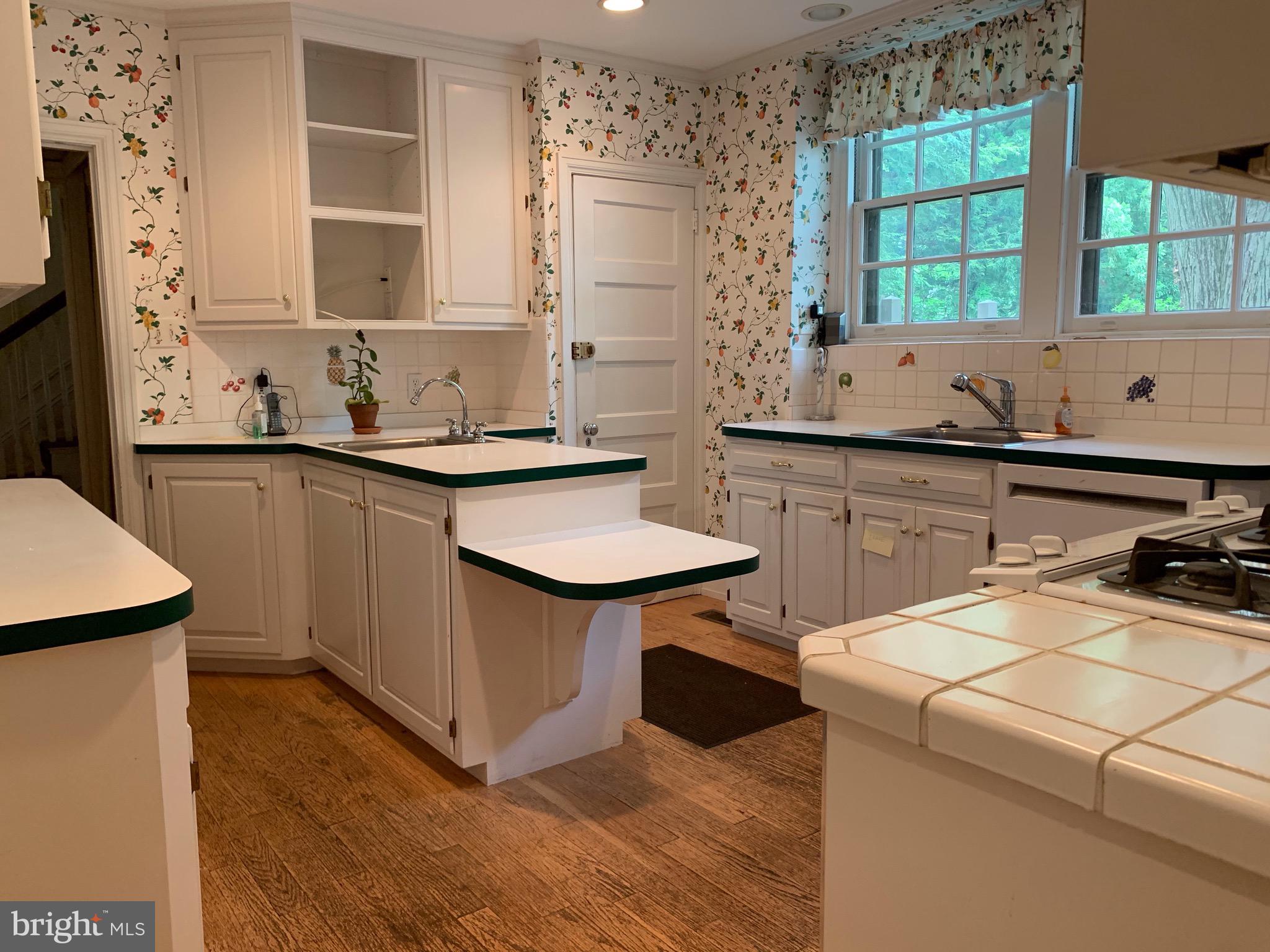 315 Kent Road Wynnewood, PA 19096 - Photo 9 of 19 a kitchen with a sink stove and cabinets