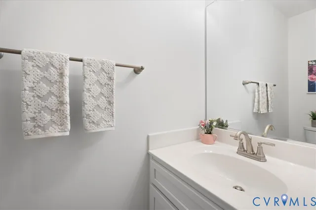 a bathroom with a sink vanity and a mirror