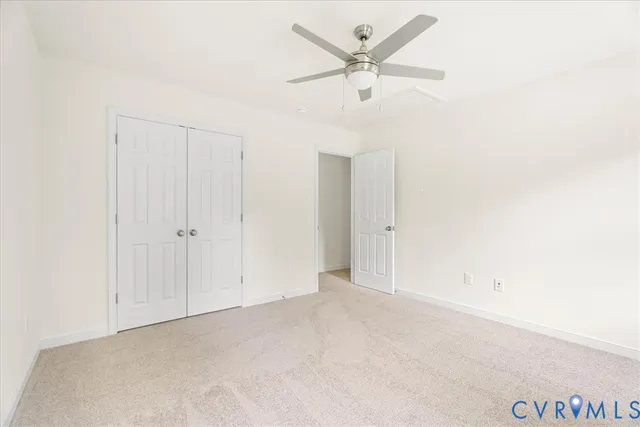 an empty room with a ceiling fan