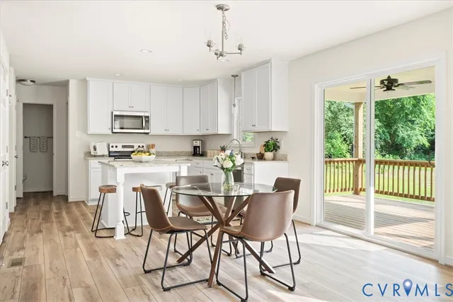 a kitchen with kitchen island wooden floors and white appliances