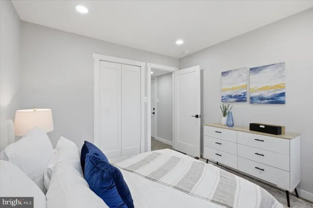 a bedroom with a bed and cabinet