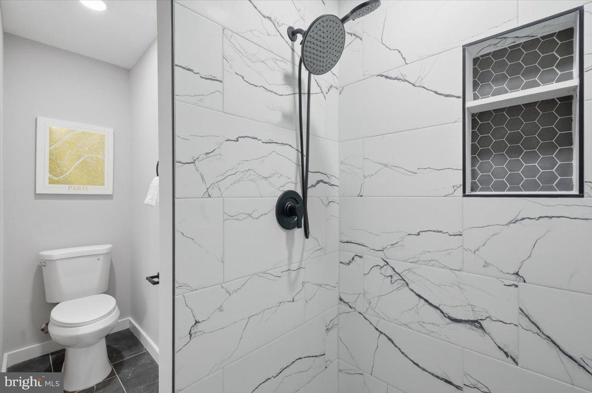 4529 Flintstone Road Alexandria, VA 22306 - Photo 5 of 37 Sleek modern bathroom with elegant tiles.