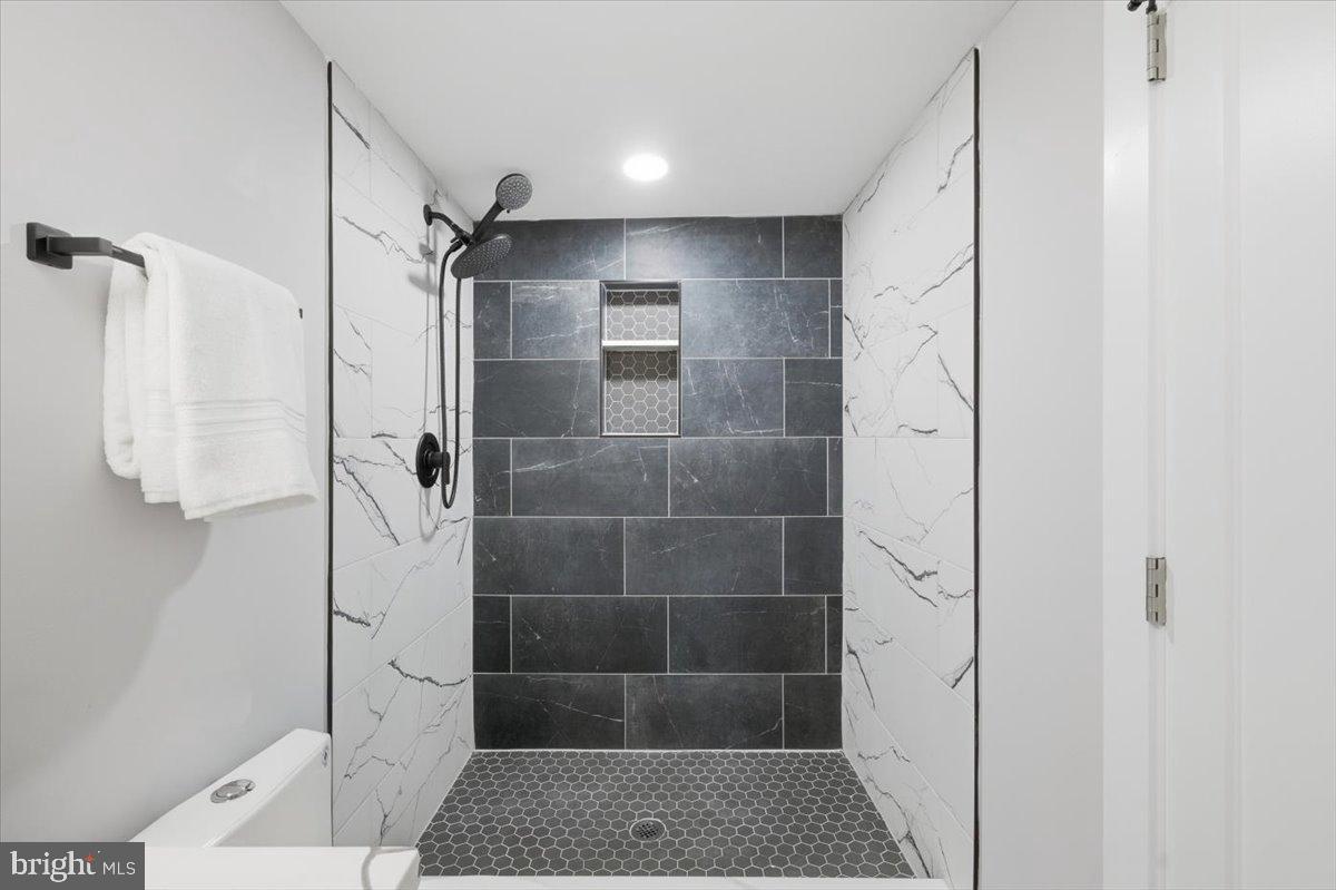 4529 Flintstone Road Alexandria, VA 22306 - Photo 7 of 37 Sleek modern shower with elegant tiles.