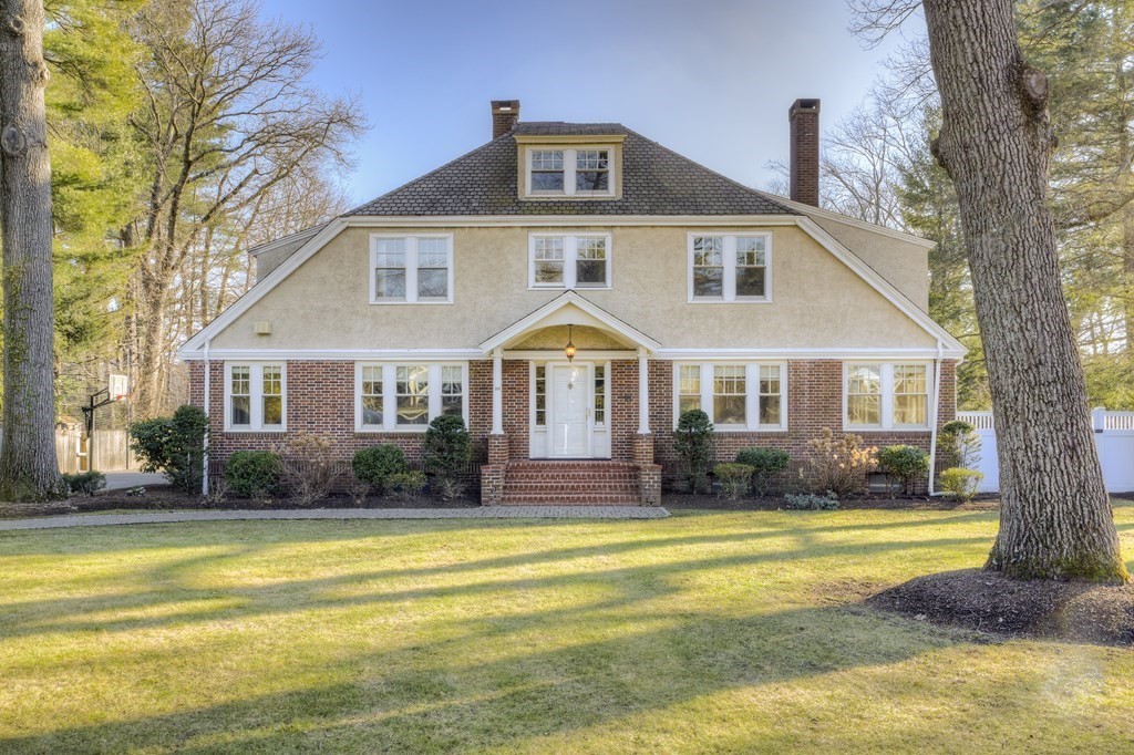 a front view of a house with swimming pool and porch