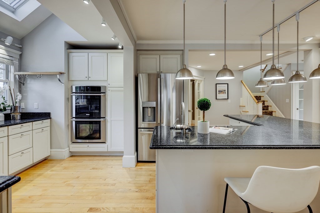 200 Chapman Street Canton, MA 02021 - Photo 11 of 42 a kitchen with stainless steel appliances granite countertop a sink refrigerator and cabinets