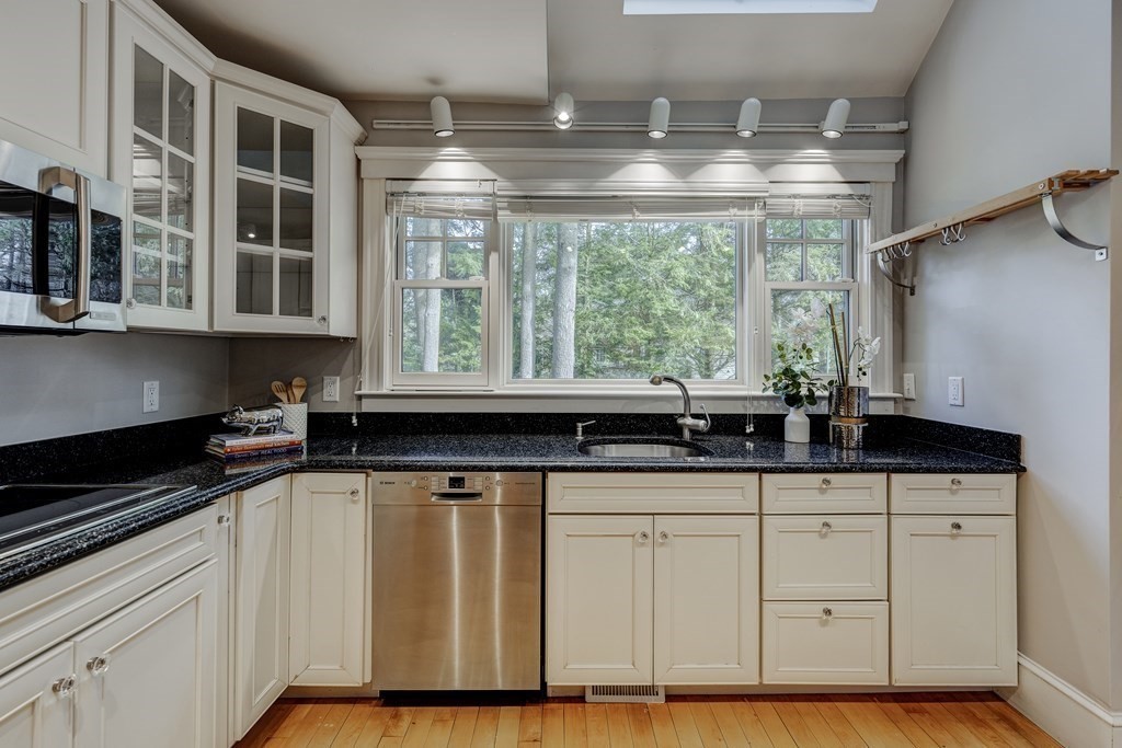 200 Chapman Street Canton, MA 02021 - Photo 12 of 42 a kitchen with granite countertop a sink and a white wooden cabinets
