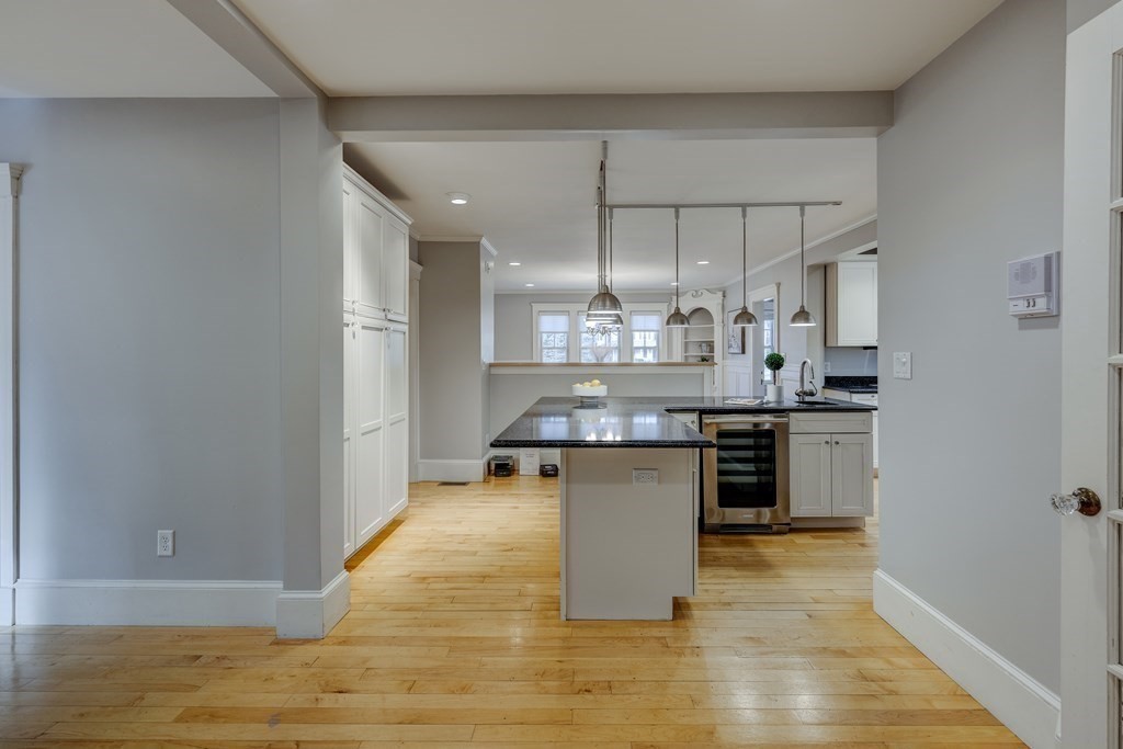 200 Chapman Street Canton, MA 02021 - Photo 14 of 42 a kitchen with stainless steel appliances a dining table chairs and granite counter tops