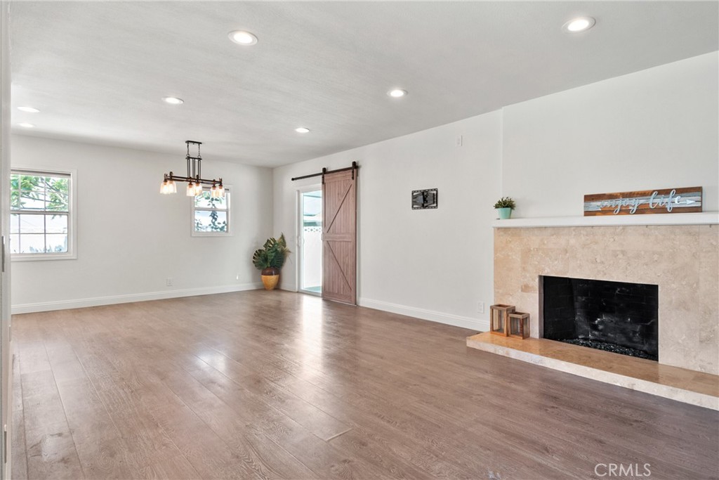1805 West Random Drive Anaheim, CA 92804 - Photo 26 of 46 a view of a livingroom with fireplace wooden floor and windows