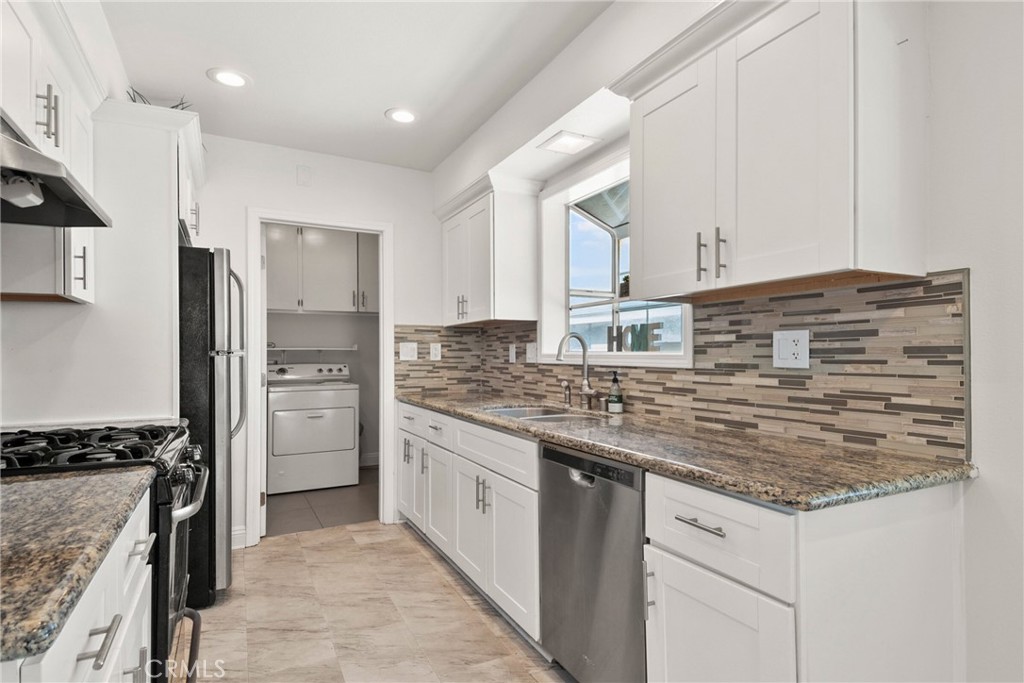 1805 West Random Drive Anaheim, CA 92804 - Photo 31 of 46 a kitchen with stainless steel appliances granite countertop a stove and a refrigerator