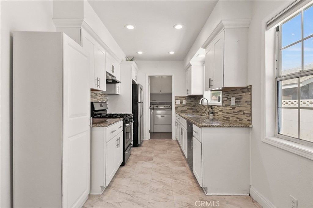 1805 West Random Drive Anaheim, CA 92804 - Photo 32 of 46 a kitchen with stainless steel appliances granite countertop a refrigerator and a stove top oven