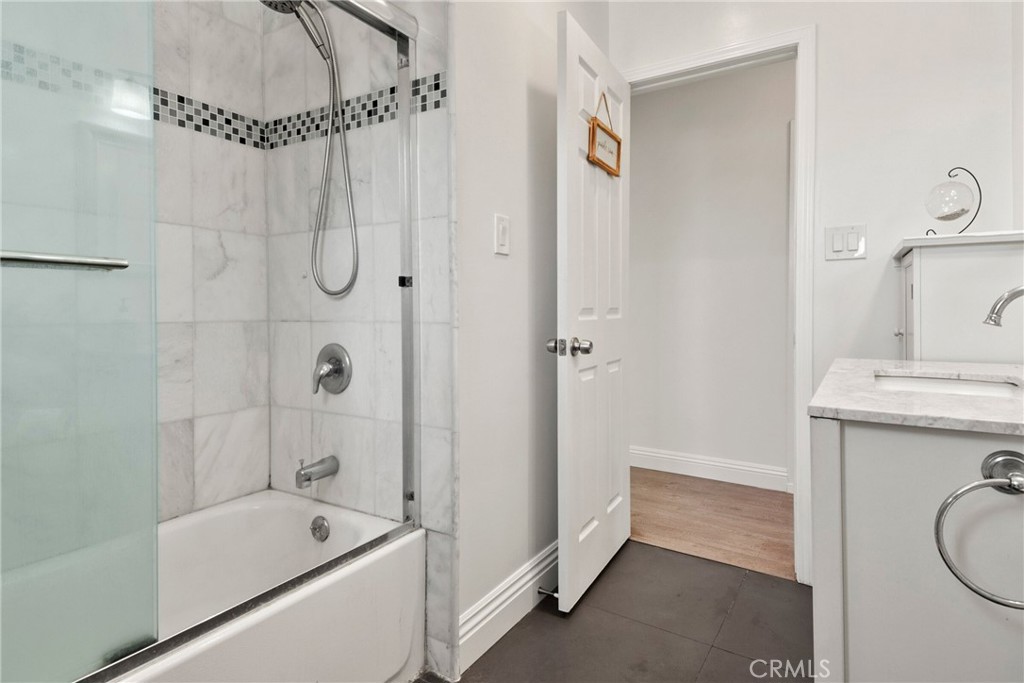 1805 West Random Drive Anaheim, CA 92804 - Photo 46 of 46 a bathroom with a tub a sink a mirror and a shower