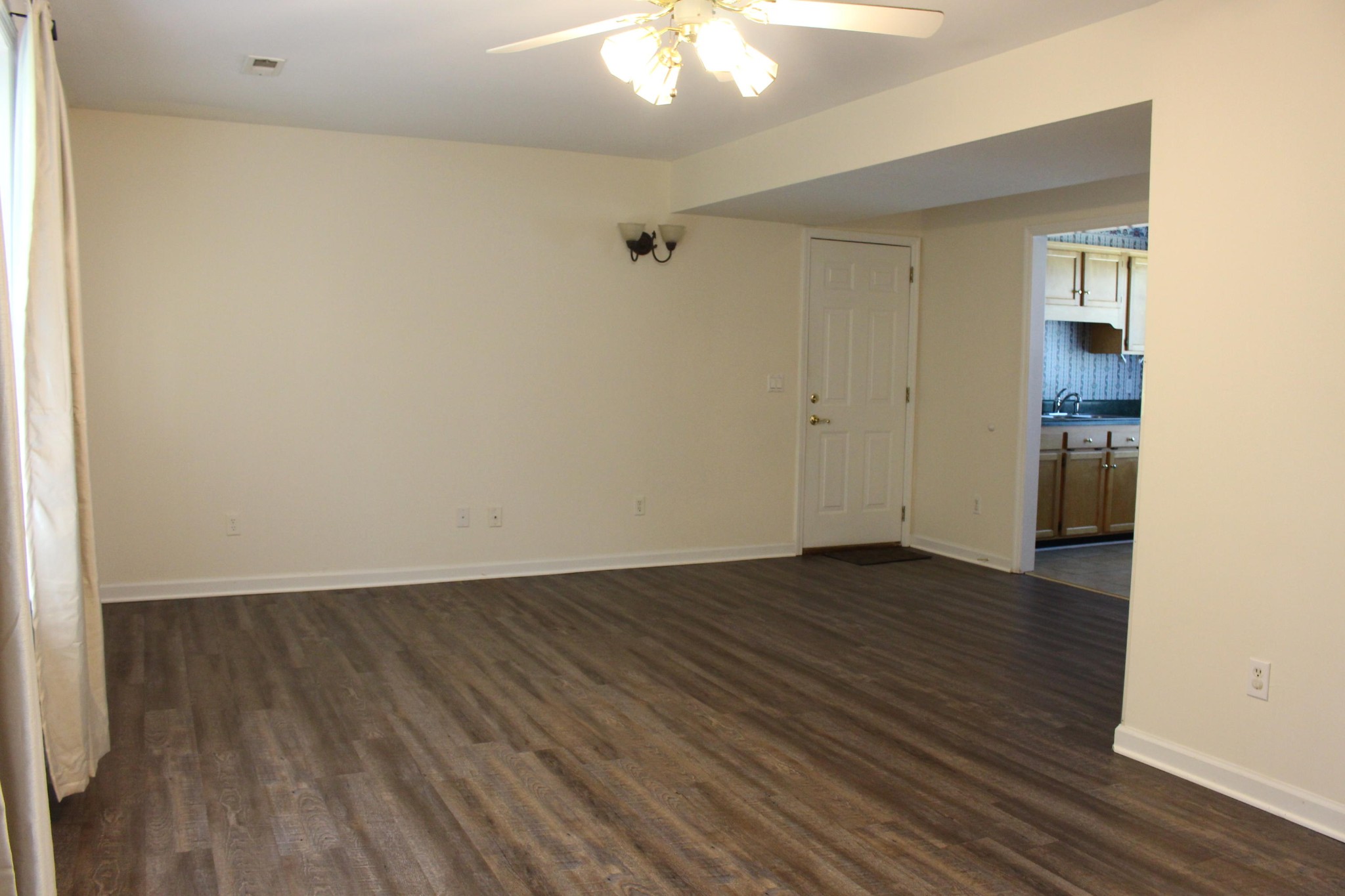 2133 Jenkins Road Chattanooga, TN 37421 - Photo 5 of 10 a view of an empty room with wooden floor and a window