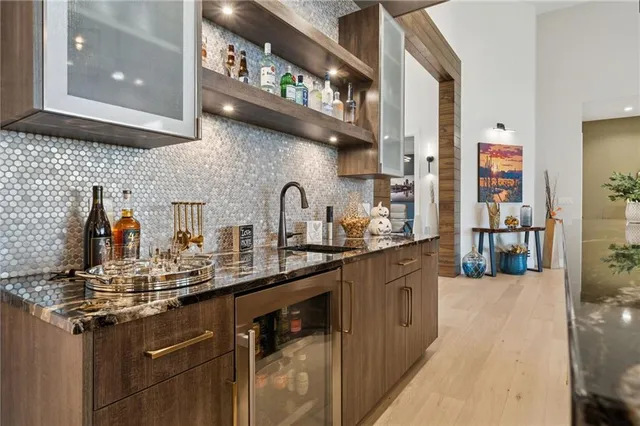 a kitchen with stainless steel appliances granite countertop a sink and cabinets