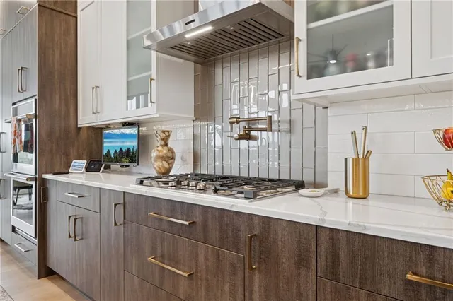a kitchen with stainless steel appliances granite countertop a sink and cabinets