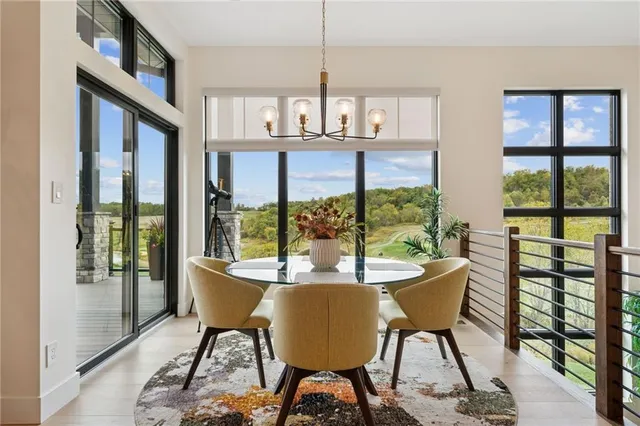 a dining room with furniture a chandelier and wooden floor