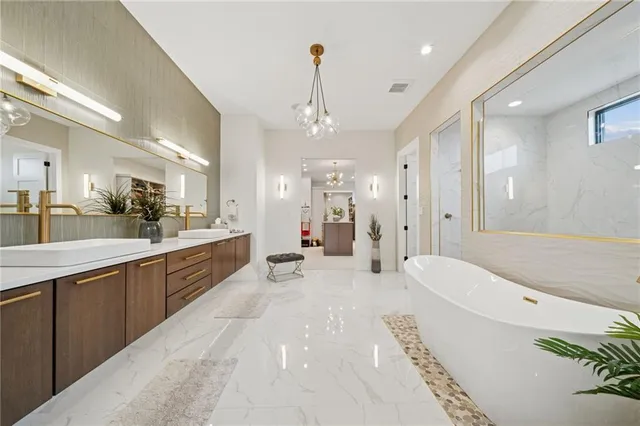 a large white bathroom with a large tub