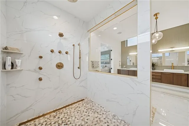 a bathroom with a glass shower door