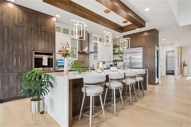 a dining hall with stainless steel appliances a table and chairs